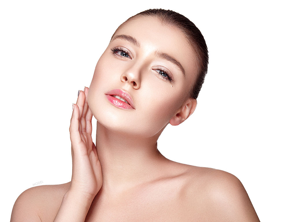 Woman with clear skin touching her face